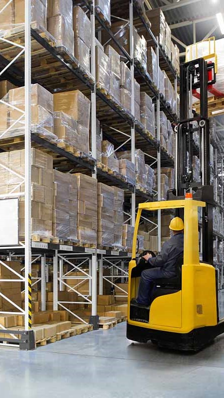 wms, Huge distribution warehouse with high shelves and forklift with operator. Bottom view.